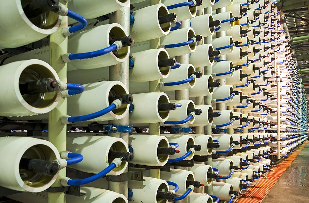 a large room of containing plastic tubes on racks with hoses attached