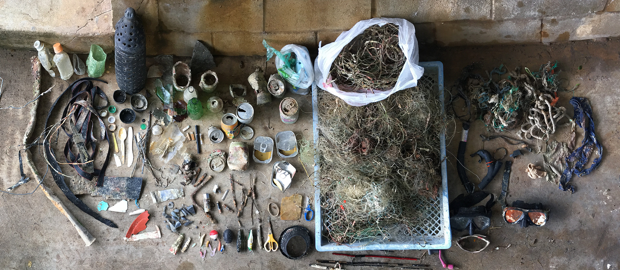 a collection of junk including fishing gear and aluminum cans