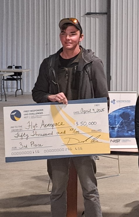 Person holding a large check