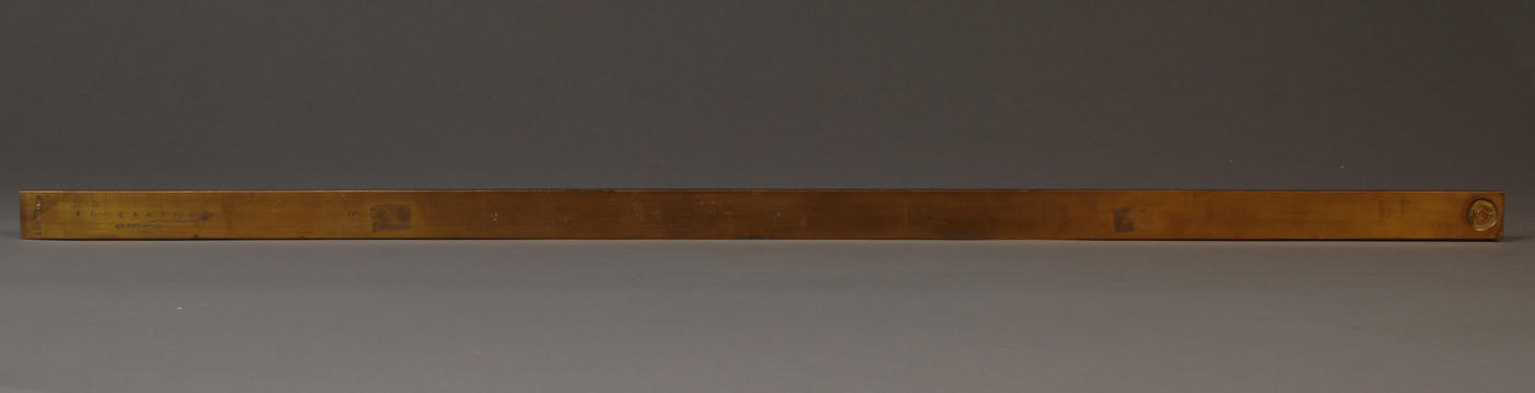 Brass Mexican Vara on gray background