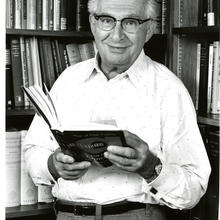 Jacob Rabinow holding a book