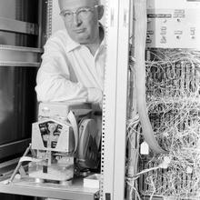 Rabinow leans on his letter sorting machine