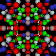red, blue, grey, brown and blue spheres representing aluminum, lithium and copper atoms organized in a geometric pattern