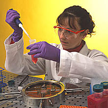 A scientist pipetting