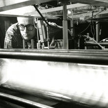 Ken leaning over a long glass tube