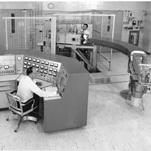Two men in a room full of scientific equipment