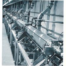 A long metal pipe is divided into sections.