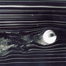 Photograph shows airflow past spinning ball in a wind tunnel.