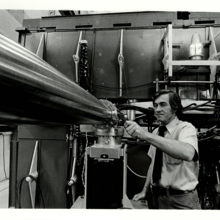 A man adjusts a fitting on a metal pipe