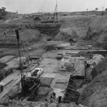 Large excavation with equipment in hole