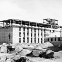 A building under construction is surrounded by scaffolding.