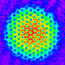 purple/blue pattern on edge with circle in the middle with bright blues, greens, yells and reds