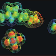 Black background. Blogs in blue, green, yellow and orange with what looks like netting around them