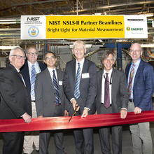 Group of executives performing ribbon cutting to open NIST beamlines at Brookhaven National Lab NSLS-II