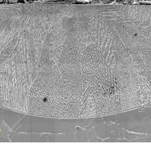 Image of an elongated hemisphere etched on a surface