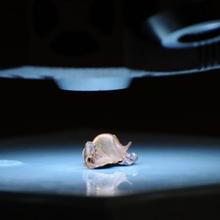 a severely deformed Kennedy bullet illuminated on a platform beneath the camera