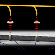 Micrograph shows horizontal yellow line connecting to five vertical pillars.