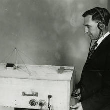 physicist Francis Dunmore operates a model illustrating the radio beacon system used in guiding aircraft
