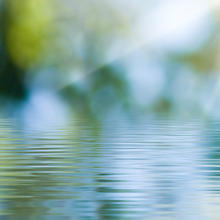 banner image showing still water with slow ripples across it on a beautiful sunny day