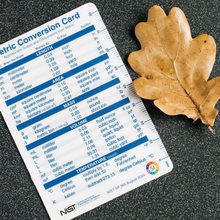 NIST unit conversion card ruler measures an autumn oak leaf