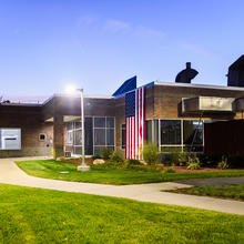 Photo of NHQ-MEC building on Veterans Day with the USA flag hanging