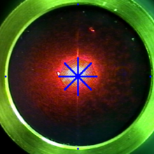 microphone diaphragm with laser spot and overlaid laser scan pattern