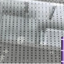 Circular metallic wafer has a grid of tiny holes. Inset shows close-up of grid with square holes. 