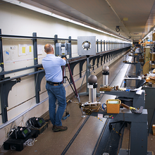 A participant performing relative range measurements in the long length tape tunnel facility at NIST. 