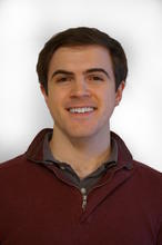  Joshua Taillon, a person with short brown hair, smiling for the camera. 