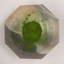 a green powder encased in clear plastic