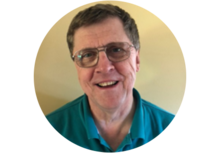 person with glasses and short gray-brown hair