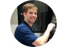 Jake Benzing places a sample into a microscope