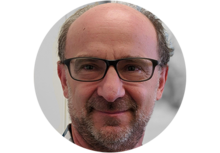 Kalman Migler, a person with a beard, wearing glasses