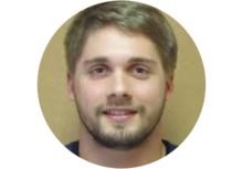 NIST's James Zuback, a person with short light brown hair and a beard, smiles for the camera
