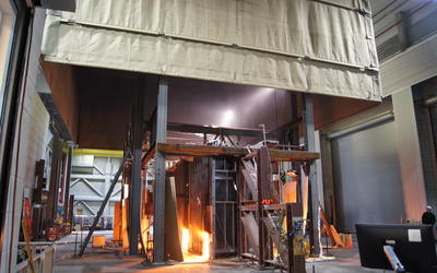 A fire test of an office building floor replica occurring in a fireproof compartment.