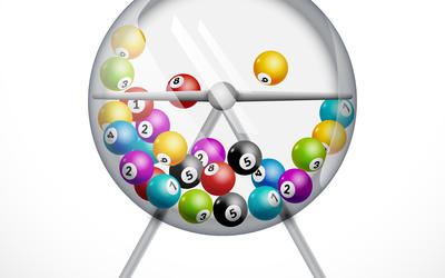 Illustration shows a lottery ball machine: a clear plastic sphere on a stand, half-filled with colorful numbered balls. 