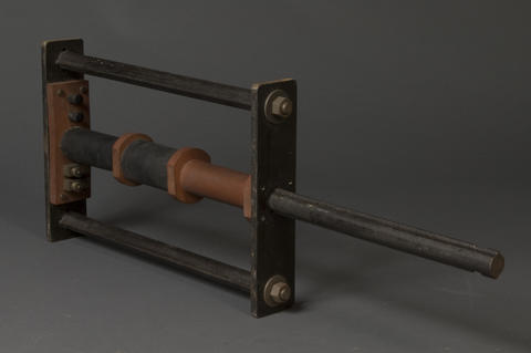 Reference specimen holder with extension pole out used to magnetically compare prison bars, circa 1930s.