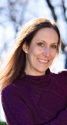 Picture of Lisa outdoors, wearing a maroon sweater.