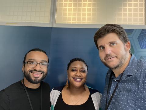 three smiling people