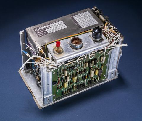 Small rectangular device is packed with wires, circuits and knobs.