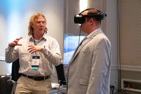 PSCR staff member demoing an AR headset with a 5x5 attendee