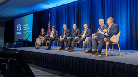 Panel of speakers on stage for plenary session at 5x5.