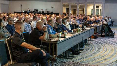 Attendees sitting in a ballroom for a plenary session at 5x5