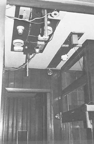 black and white image of smoke detectors on a ceiling