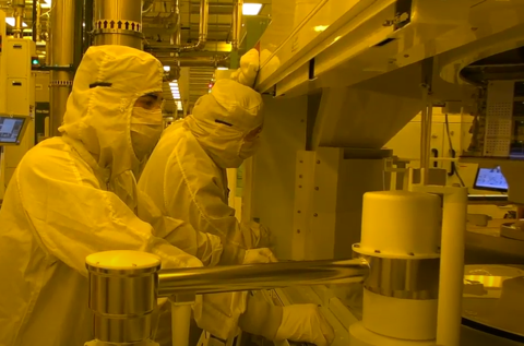 Photo of workforce in clean suits in the manufacturing fab center in New York