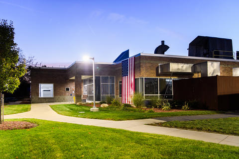 Photo of NHQ-MEC building on Veterans Day with the USA flag hanging