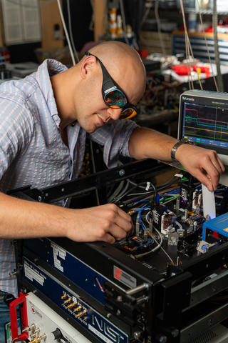 Man with safety glasses working on clock