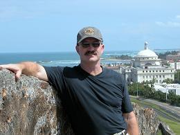 Dave McColskey stands overlooking a coastal city.