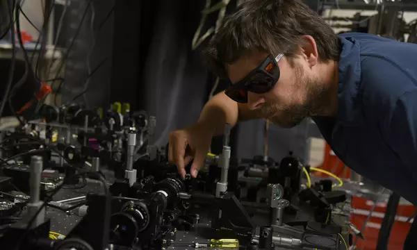 NIST physicist Krister Shalm with the photon source used in the Bell test