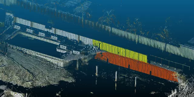 Lidar image of building collapse site looks like a black-and-white photo with some parts of the remaining walls marked in yellow and red.